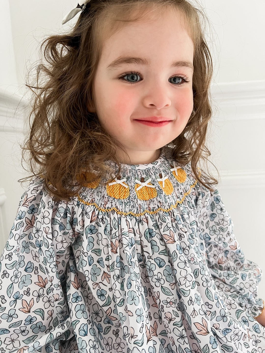 Colette Blue Floral and Pumpkin Smocked Dress