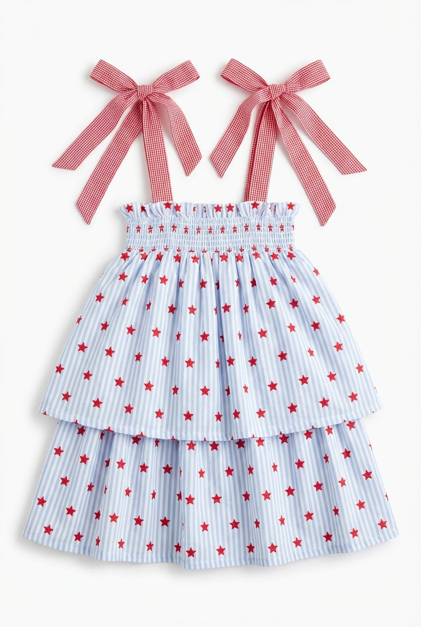 Girls blue star print dress with red gingham bow straps