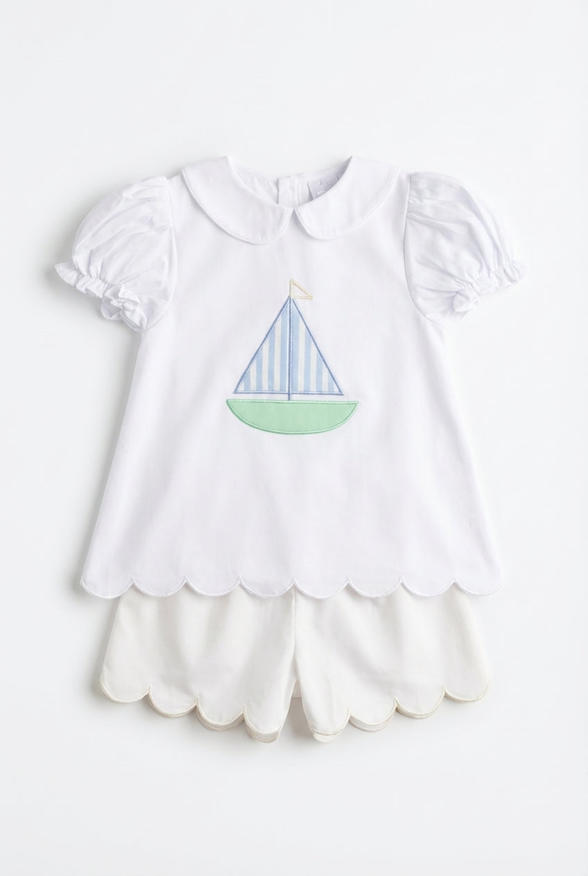 White girls two piece set with sailboat motif and scalloped hems