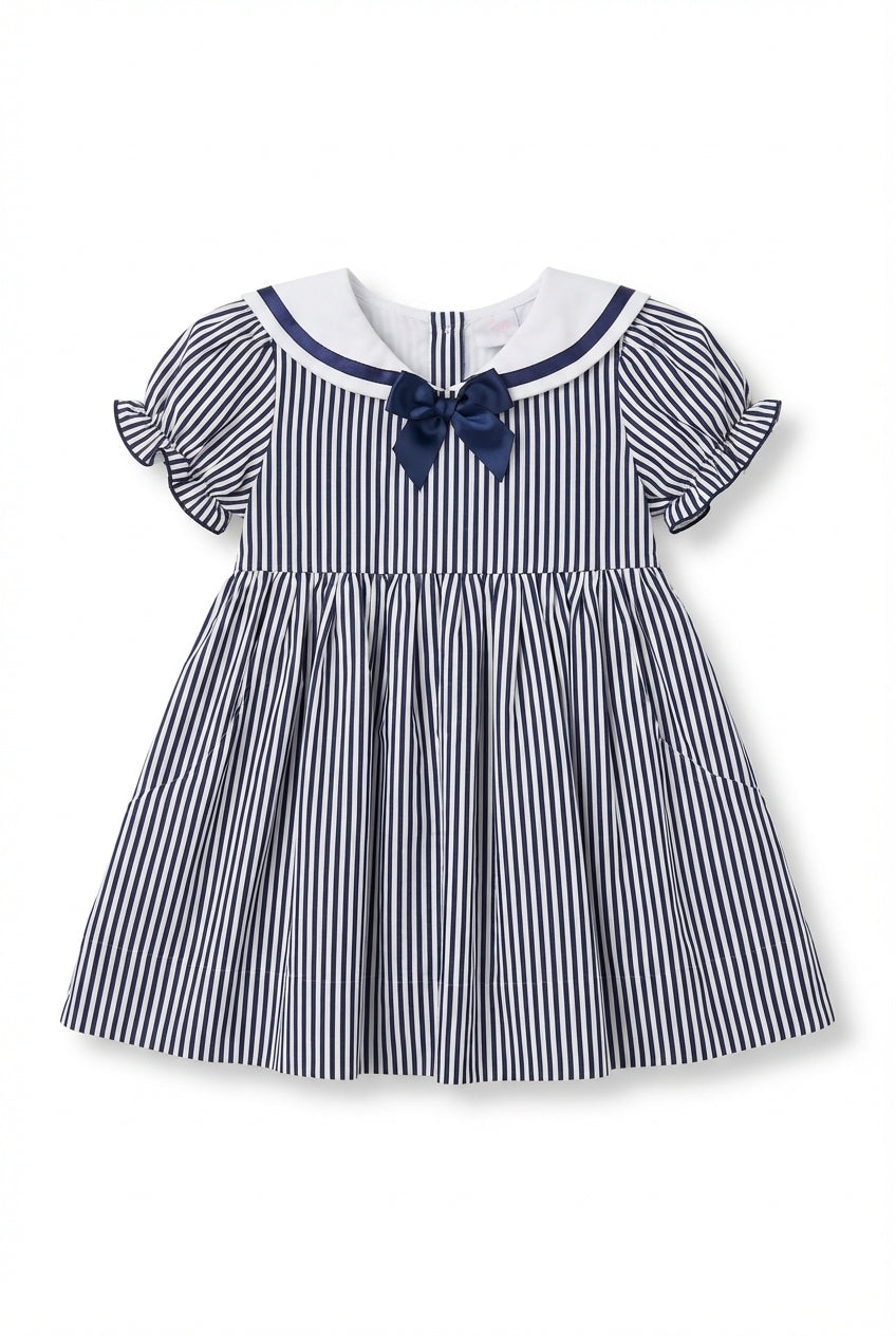 Girls navy dress with sailor collar, bow, and puff sleeves