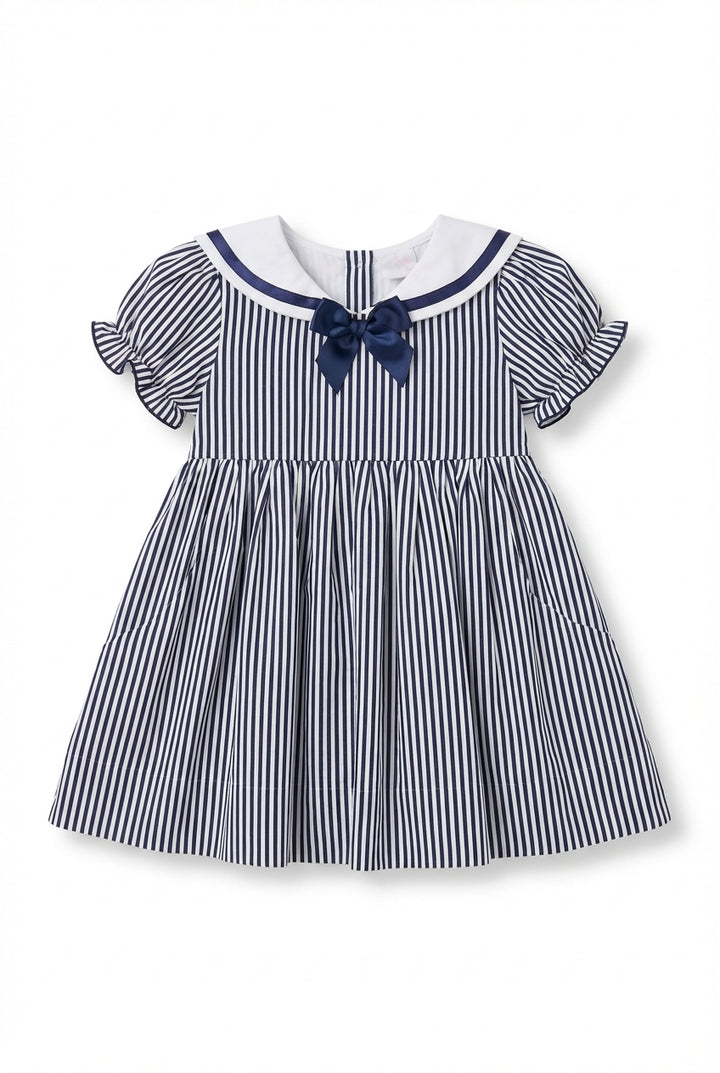 Girls navy dress with sailor collar, bow, and puff sleeves