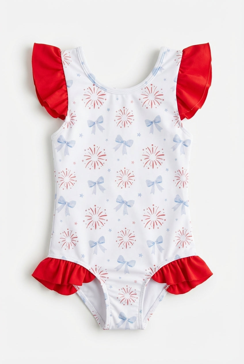 Girls white swimsuit with blue bows, fireworks, and red ruffles