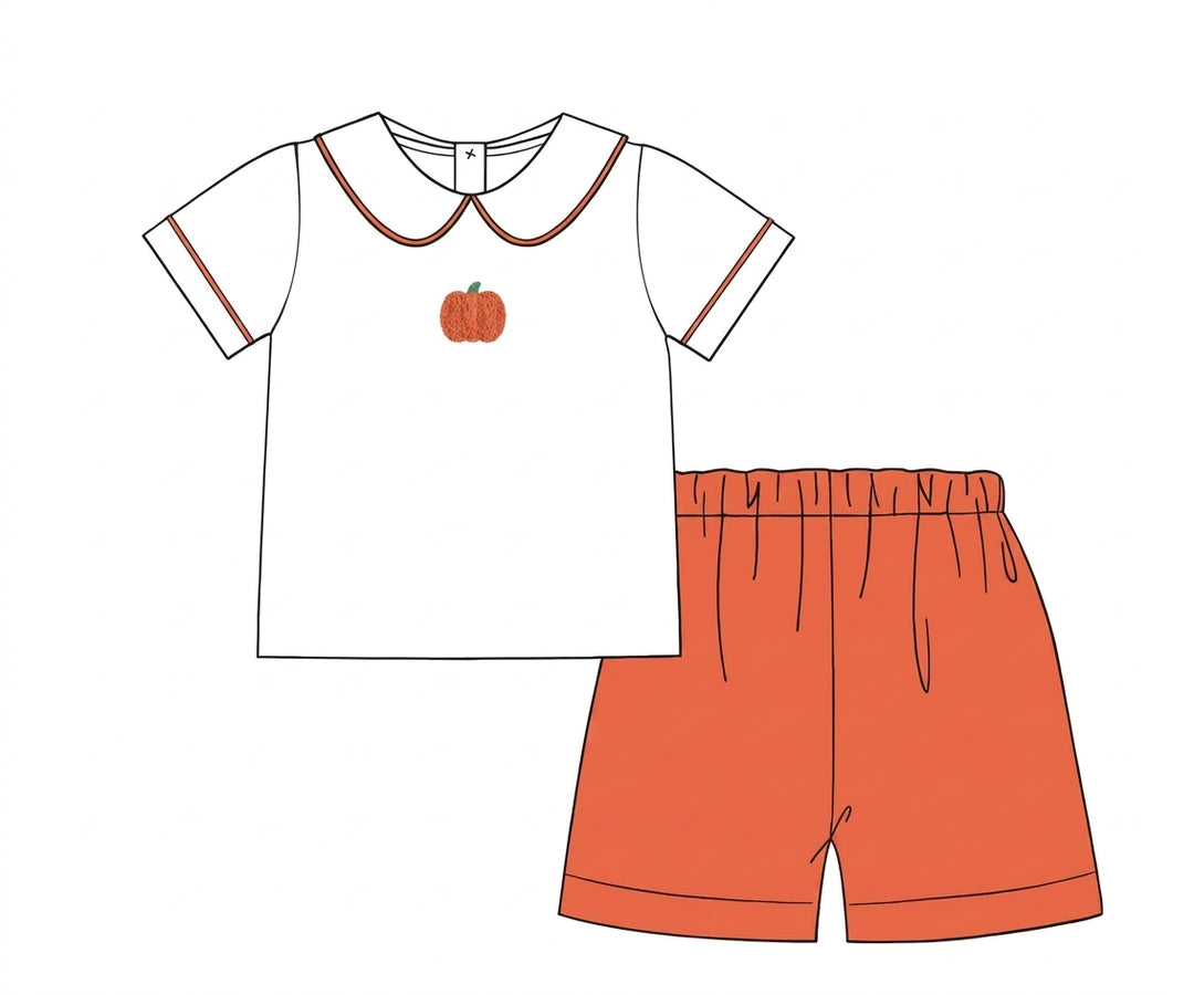 White pumpkin embroidered top with orange shorts