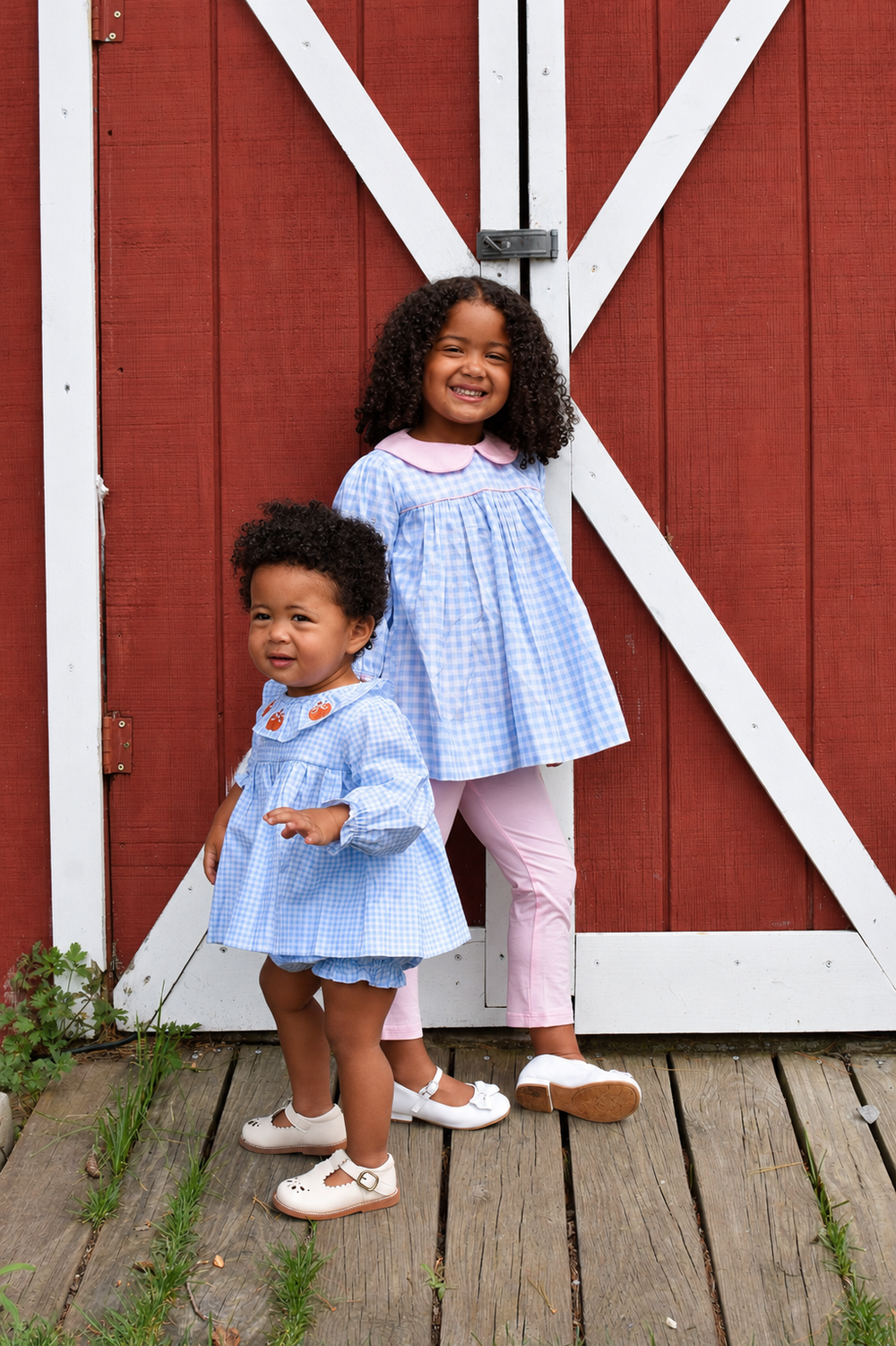Two children in blue gingham pumpkin outfits at Smolak Farms